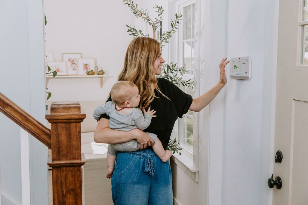 woman_using_panel_holding_baby